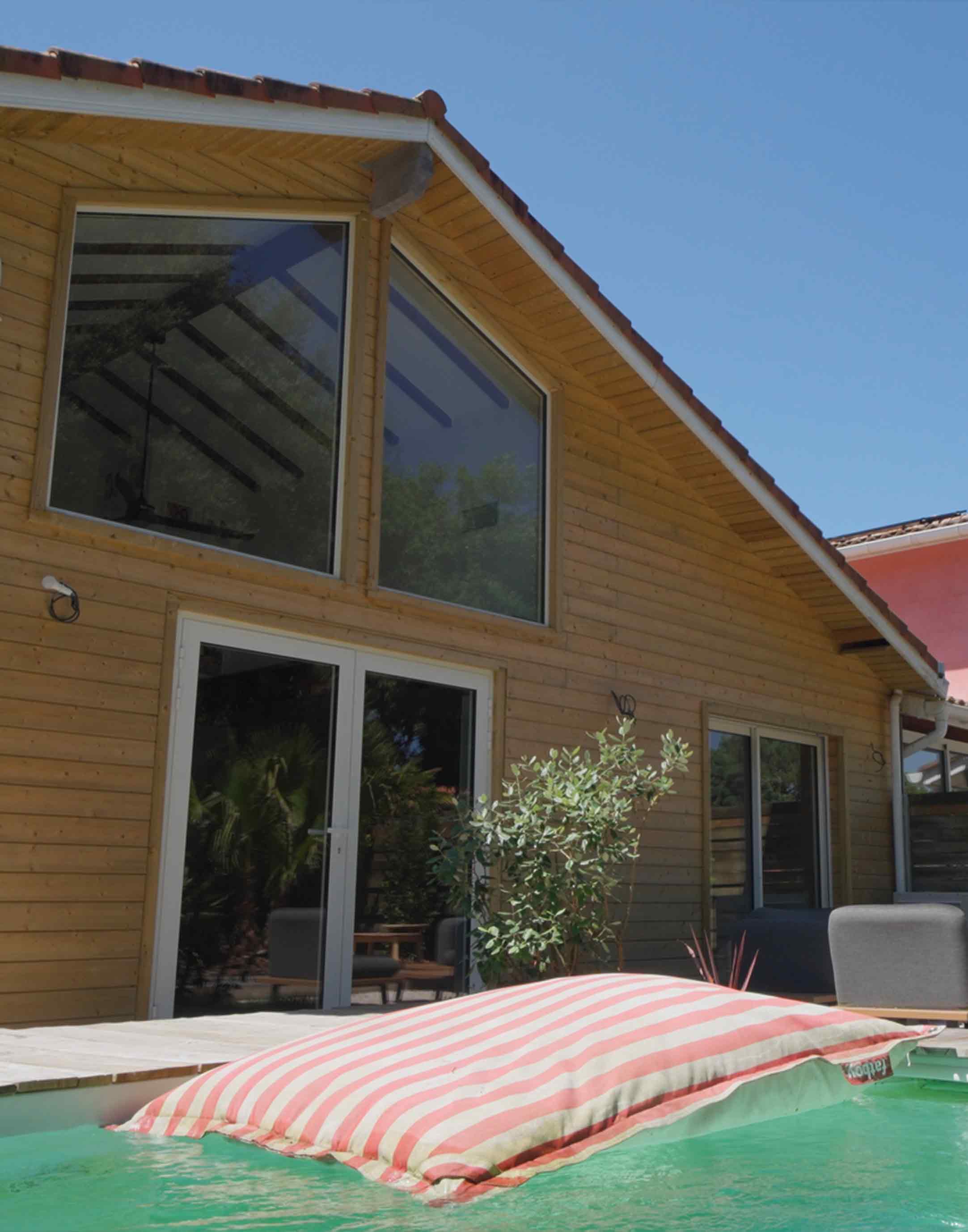 Extérieur d'une villa avec piscine et large matelas gonflable